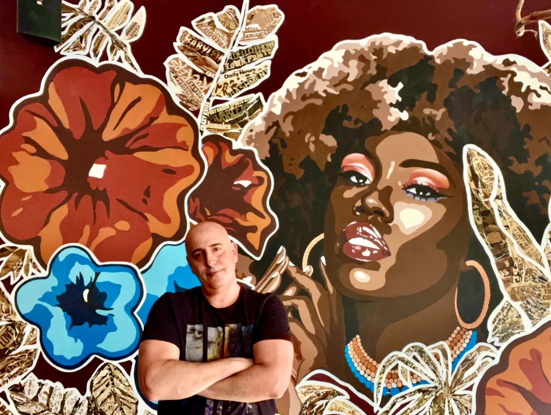Anthony Scotto in front of floral portrait mural