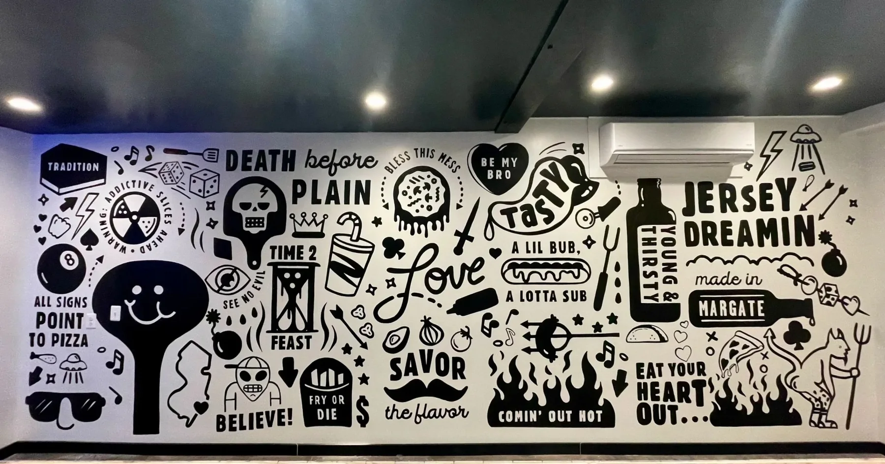 Black and white typographic word-collage mural