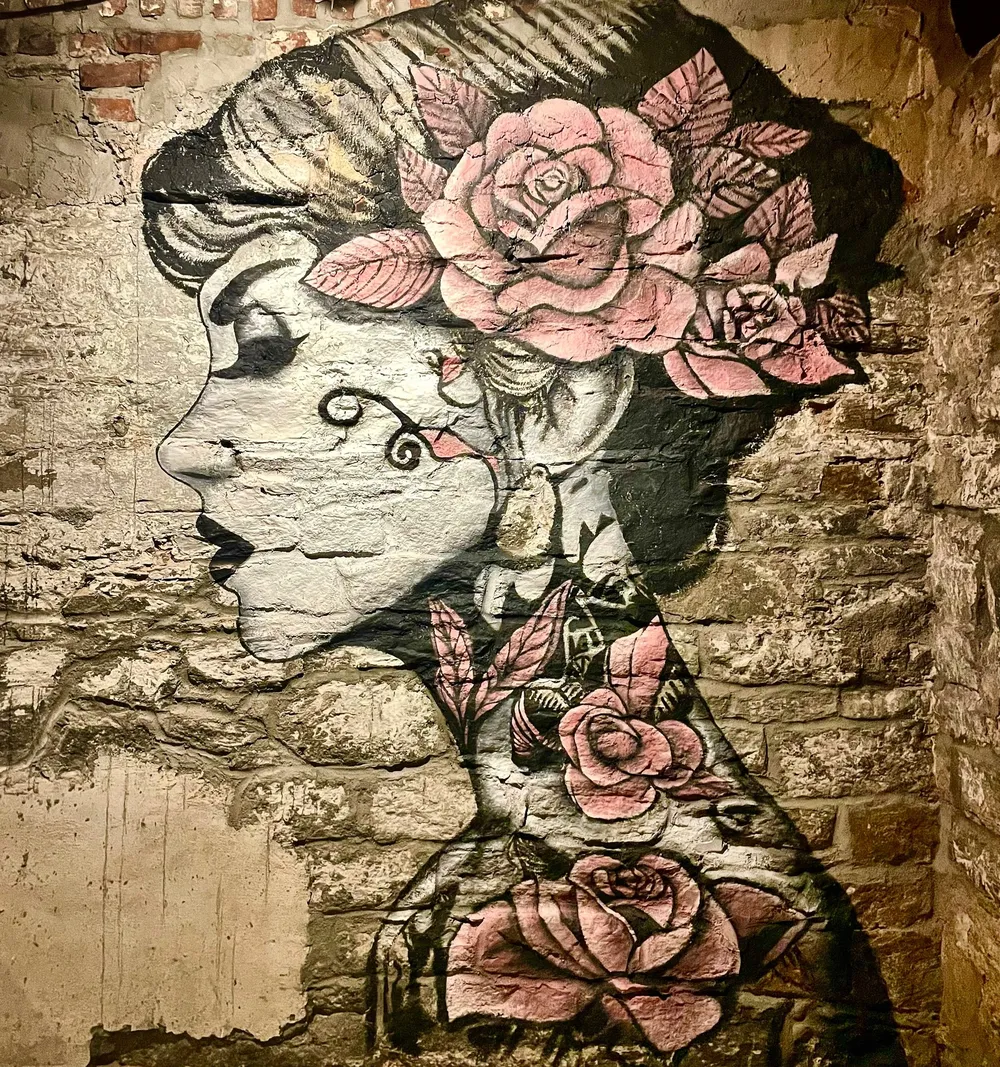 Portrait mural of a woman framed by roses